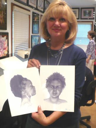 I'm holding a drawing of a little girl who couldn't be identified. I drew her portrait from her autopsy photos.