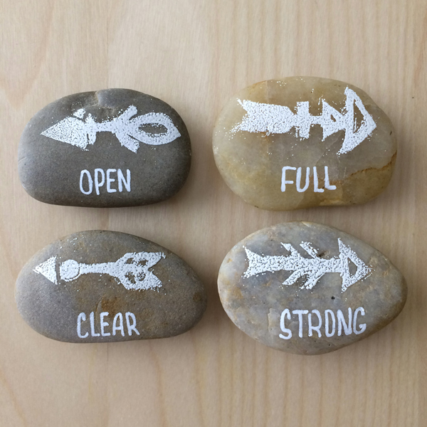 Make magnets. These, too, can be super simple. I carved some stamps and embossed the symbols on the rocks using white embossing powder, then wrote my power words with a white paint pen.