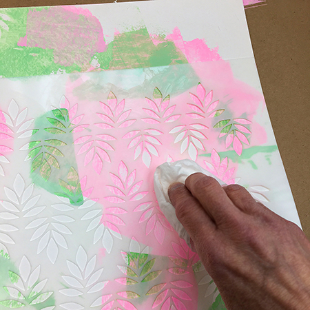 Removing acrylic paint through a stencil