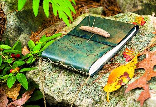 Wood-burned leather cover by Erica Ekram from Cloth Paper Scissors magazine