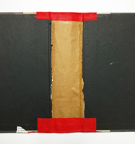 Gluing the flaps of the bookcloth to the inside of the spine
