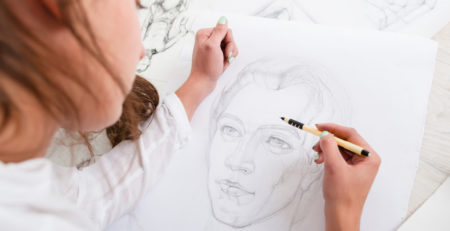 New drawing habits and 10 basics of drawing for beginner artists | Artist drawing a portrait, photo courtesy of Getty Images | Article brought to you by Artists Network