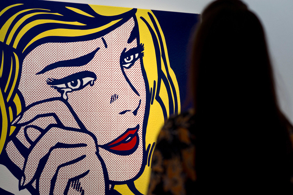 A viewer in front of 'Crying Girl' by Roy Lichtenstein (Photo by Ben Pruchnie/Getty Images)